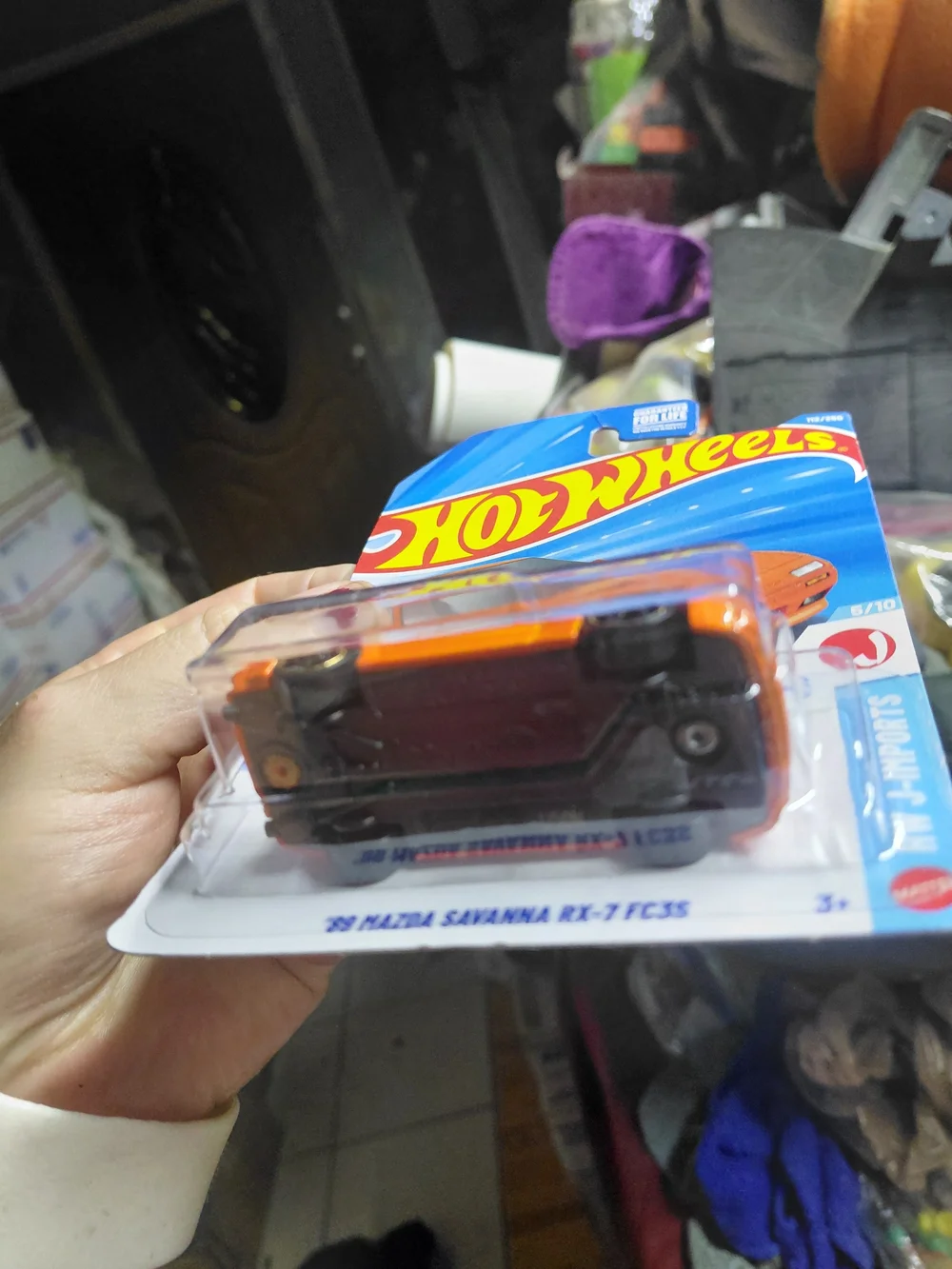 the Hot Wheels '89 Mazda Savanna RX-7 FC3S in orange, part of the 2026 HW J-Impo